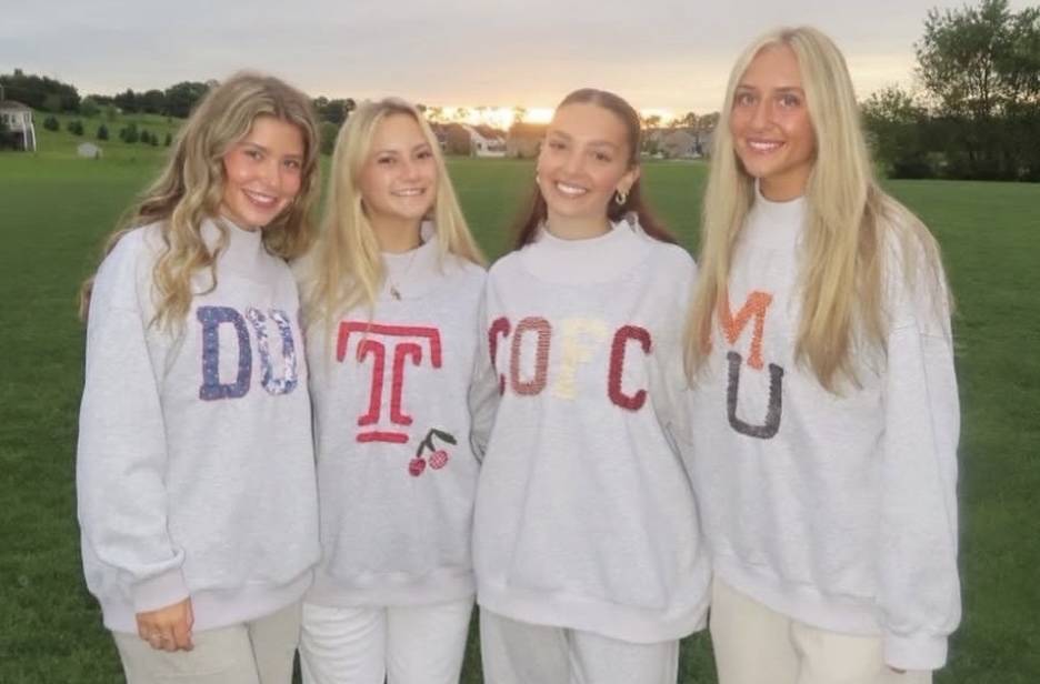 Four girls wearing custom Stitched by Reags sweatshirts
